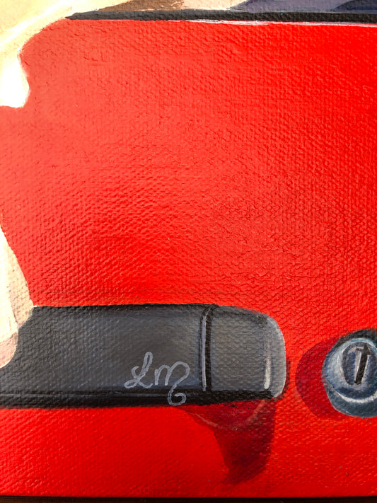 Close-up of painted car door handle on red background, pop art style, signature visible