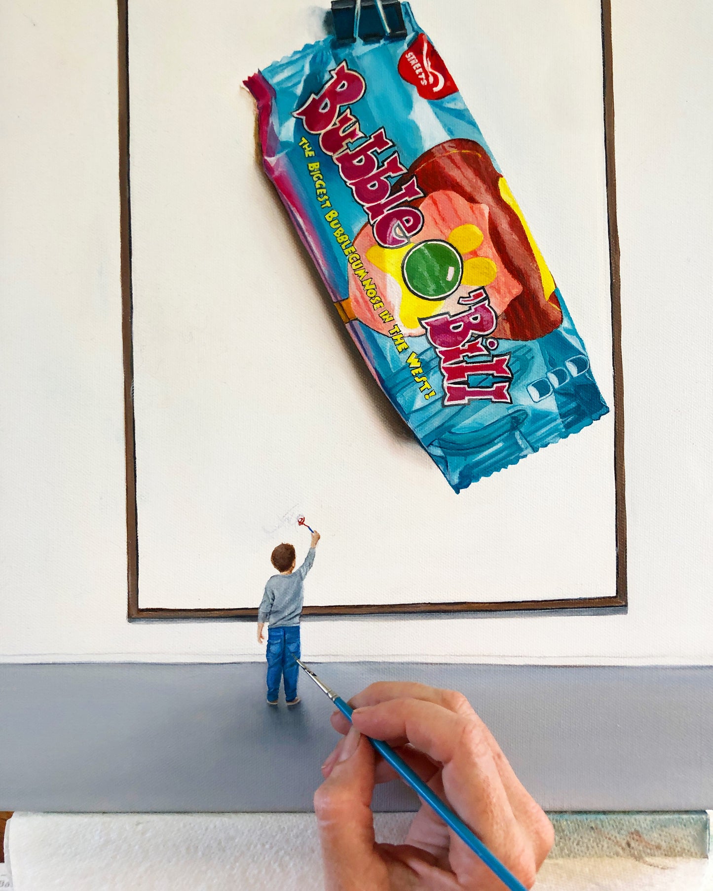 Realistic pop art painting of a hand painting a small boy admiring a Bubble O' Bill ice cream wrapper