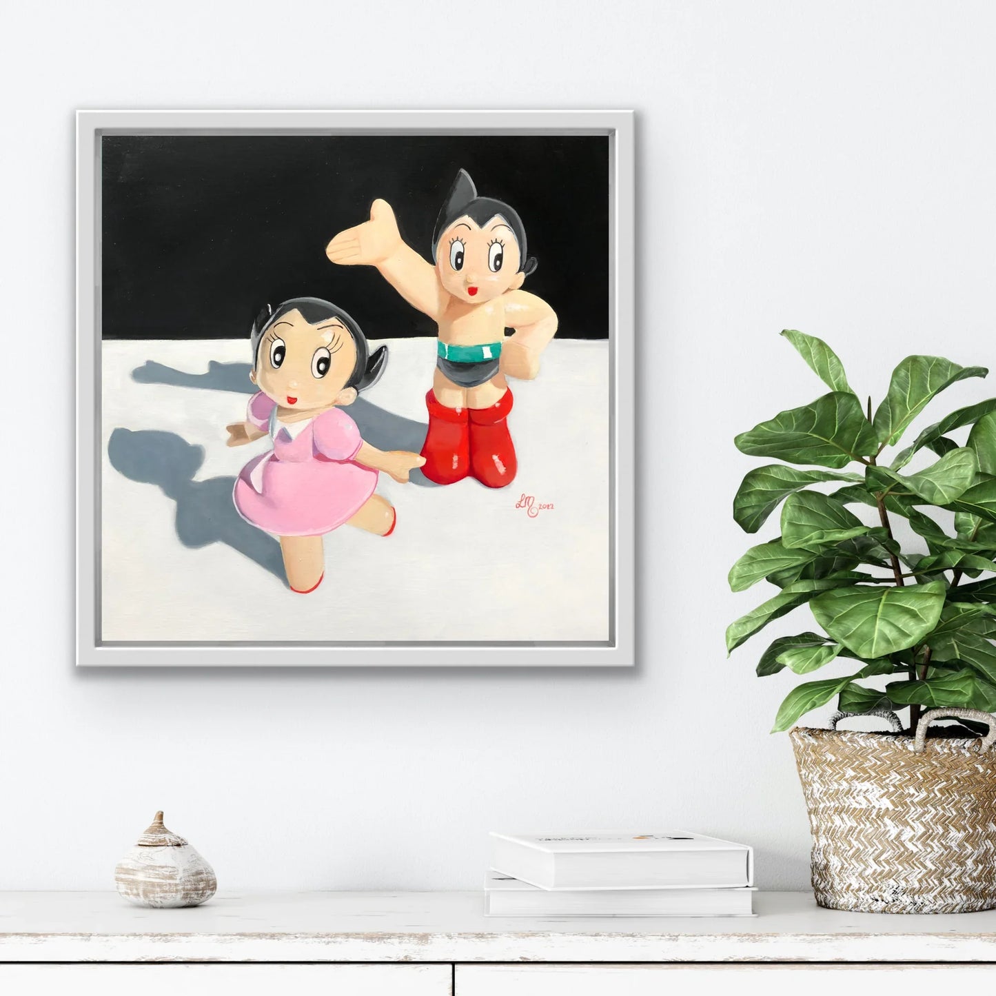 Framed pop art painting of two retro cartoon figures with bold colors on a modern wall.