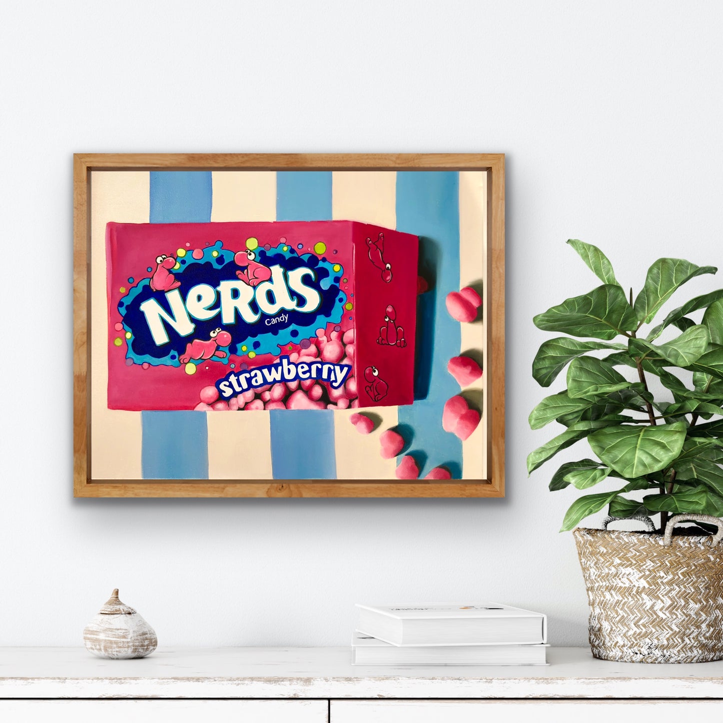 Pop art painting of Nerds strawberry candy box in wooden frame on striped wall, home decor