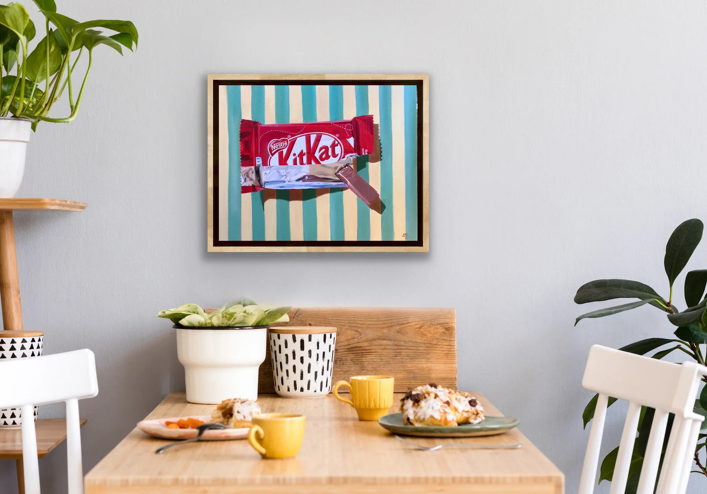 Framed pop art painting of a KitKat bar with striped background in modern dining room