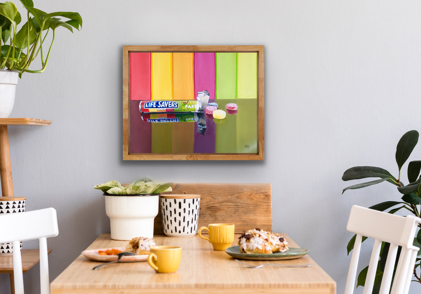Framed pop art painting of Life Savers lollies on colorful striped background, hanging in dining area