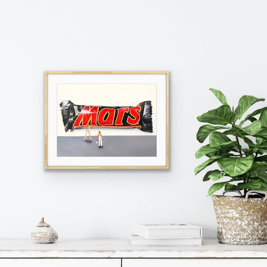 Framed pop art print featuring a Mars bar with tiny painters on a neutral wall