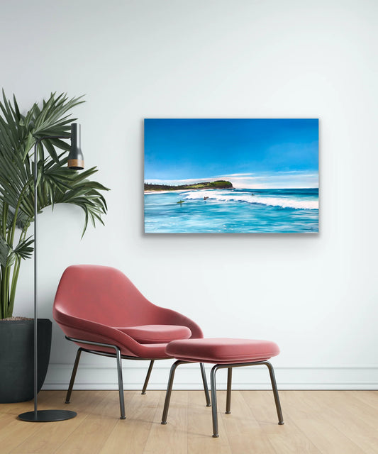 Coastal pop art painting of surfers and waves, displayed in a modern living room setting.