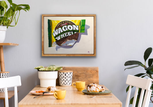 Pop art painting of a Wagon Wheel biscuit in a wooden frame on a kitchen wall