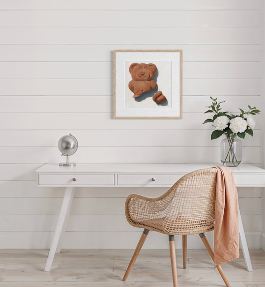 Home office with a desk, wicker chair, framed artwork, and decorative items.