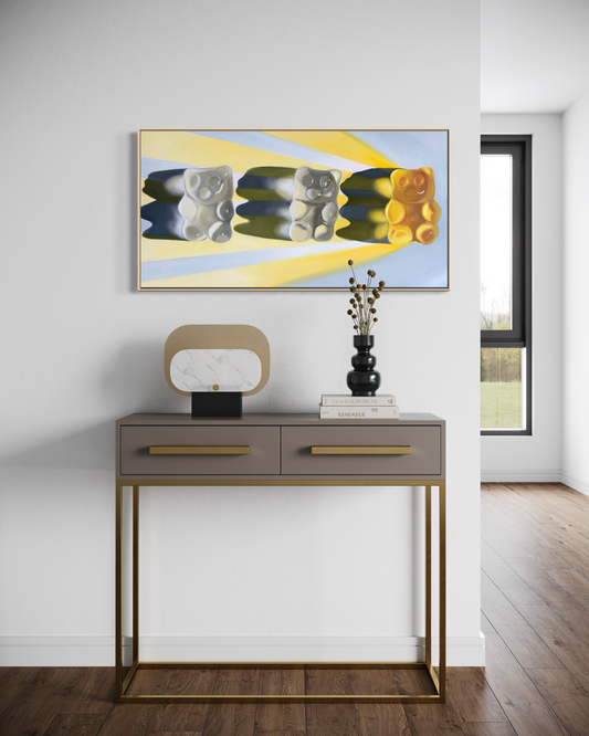 Modern with a console table and pop art painting of three gummy bears in yellows and grey tones casting a yellow light ray on the wall.