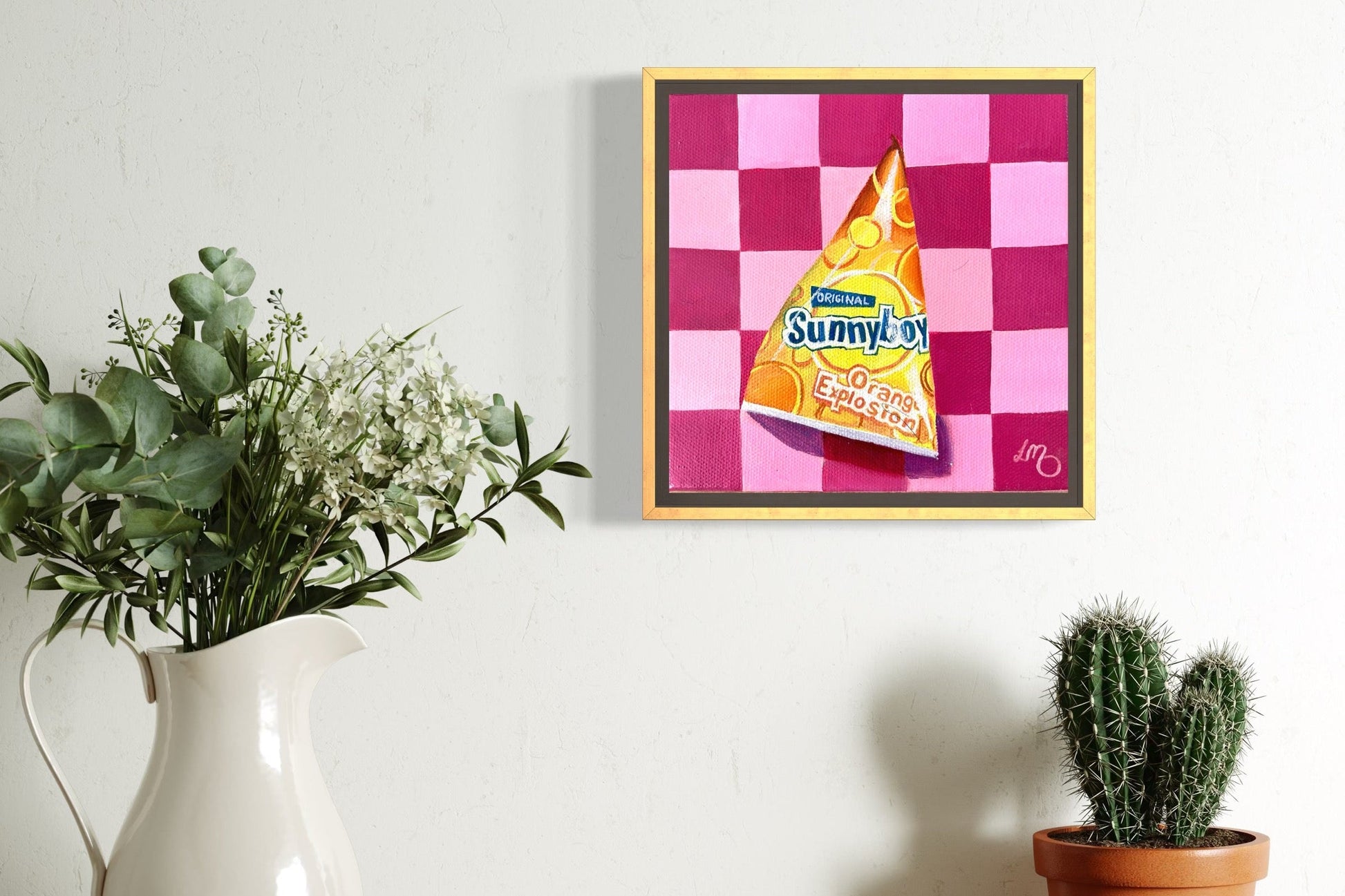 Framed artwork of a Sunnyboy on a checkered background, painted on a canvas surrounded by plants