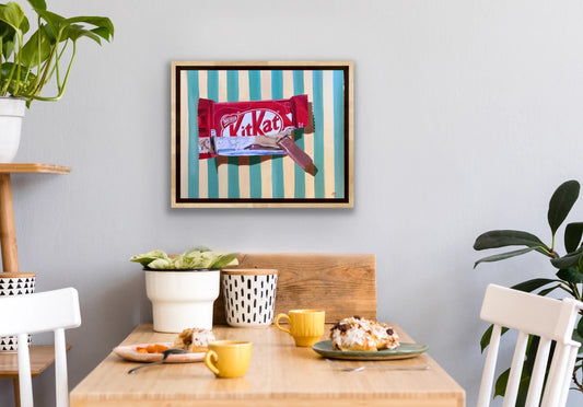 Framed pop art painting of a KitKat bar with striped background in modern dining room